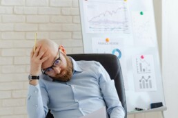 Small business CFO reviewing financial reports with a business owner