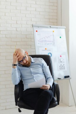 Small business CFO reviewing financial reports with a business owner